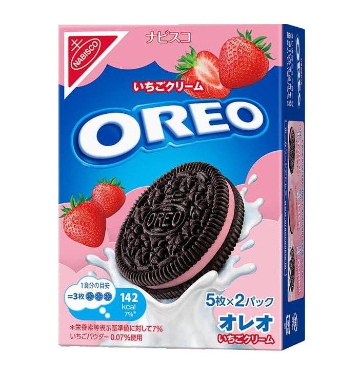 OREO strawberry cream cookie packaging with strawberries and milk splash on a pink background